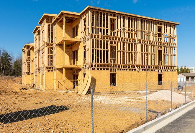 construction zone secured with a temporary fence, marked with warning signs in Chualar, CA